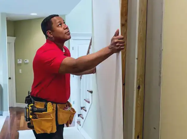 MYH Technician handing drywall in a customer's home.