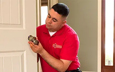 A My Handyman technician fixing a doorknob.