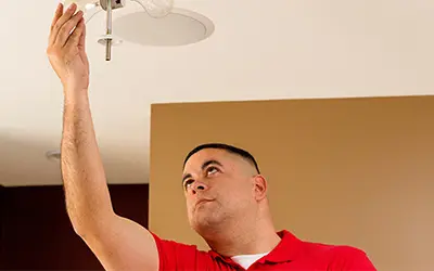 A My Handyman technician fixing a light socket.