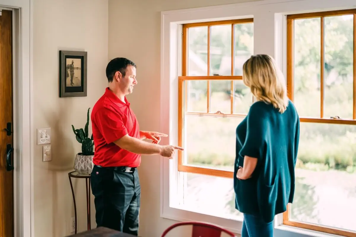 A My Handyman technician speaking with a client about her windows.