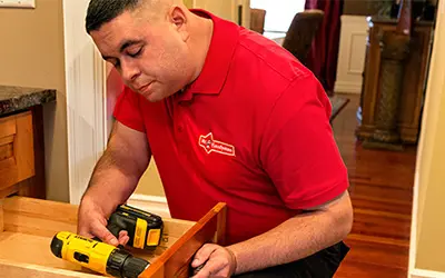 A My Handyman technician fixing a drawer.